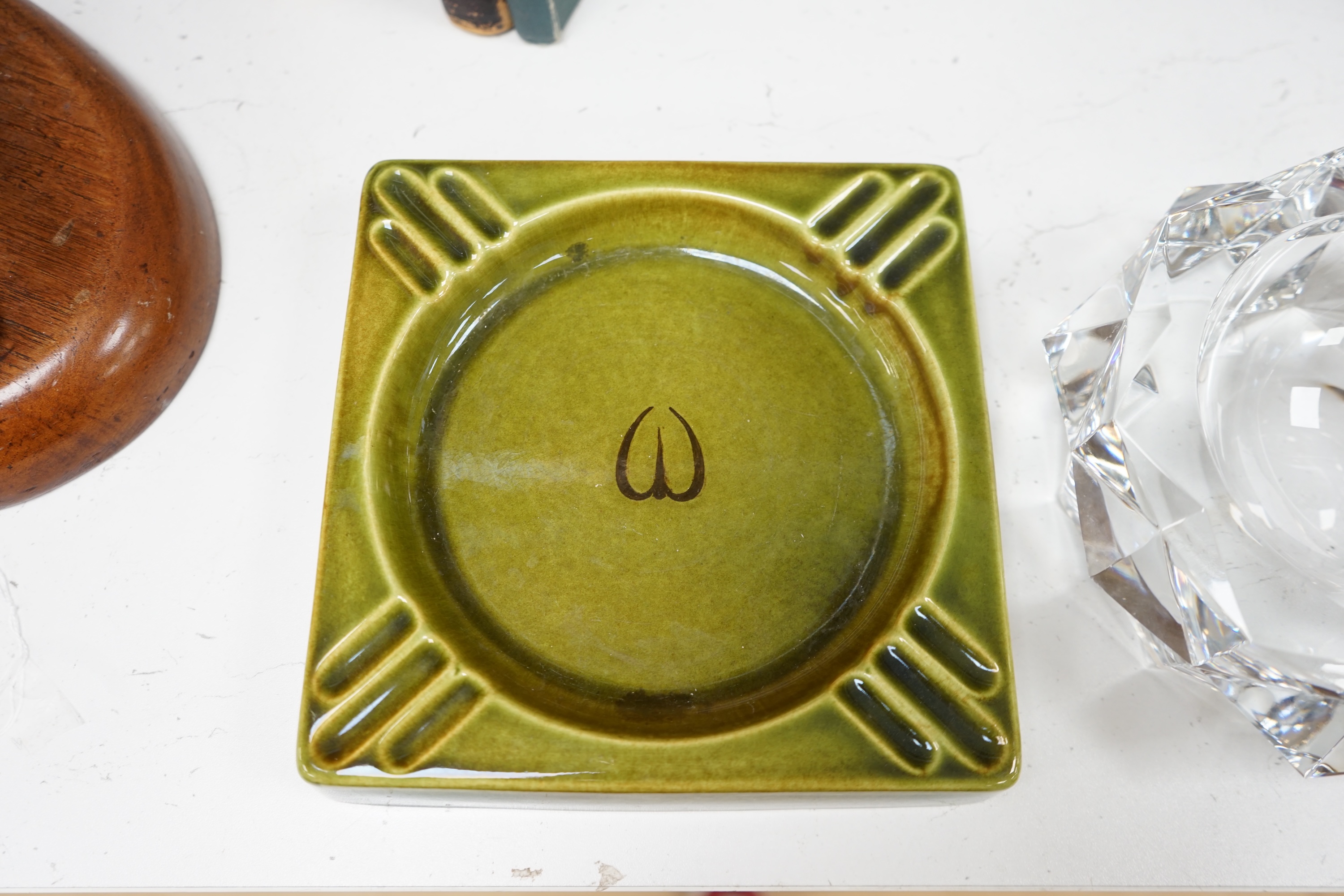 A Baccarat cut glass ashtray, 19cm diameter, and a Gefle Swedish green pottery ashtray, 20cm wide. Condition - good.